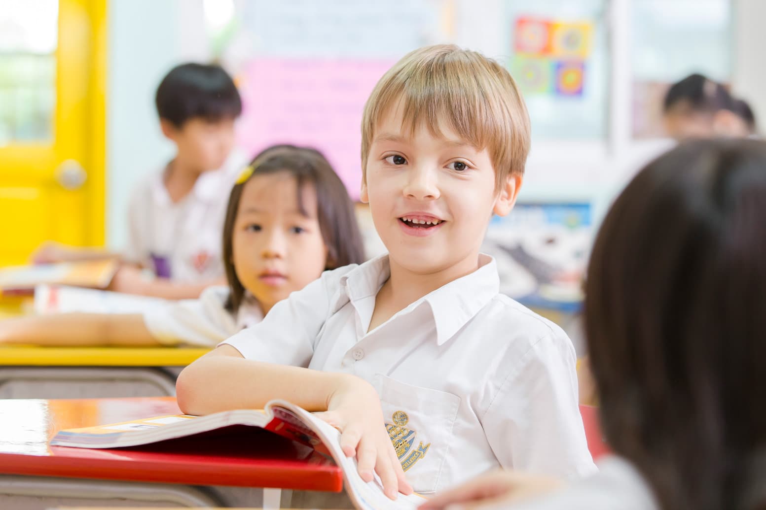 Elementary boy looking at the camera in the classroom