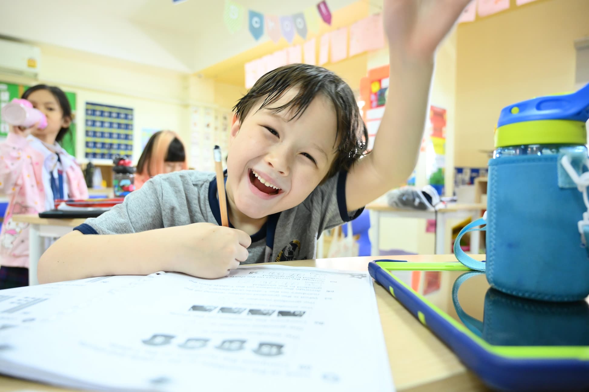 A NIVA student cheerfully doing his school work.