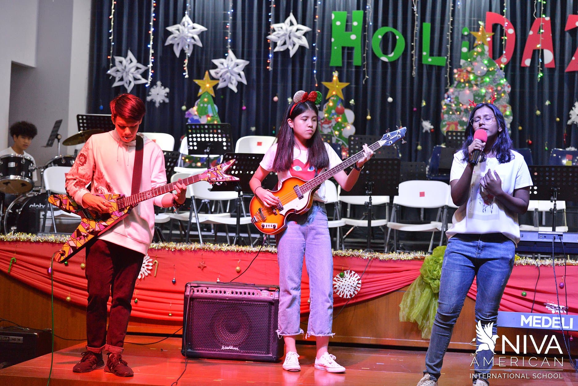 NIVA Heisler Hall (Assembly Hall) - High school band playing and singing on stage during Christmas