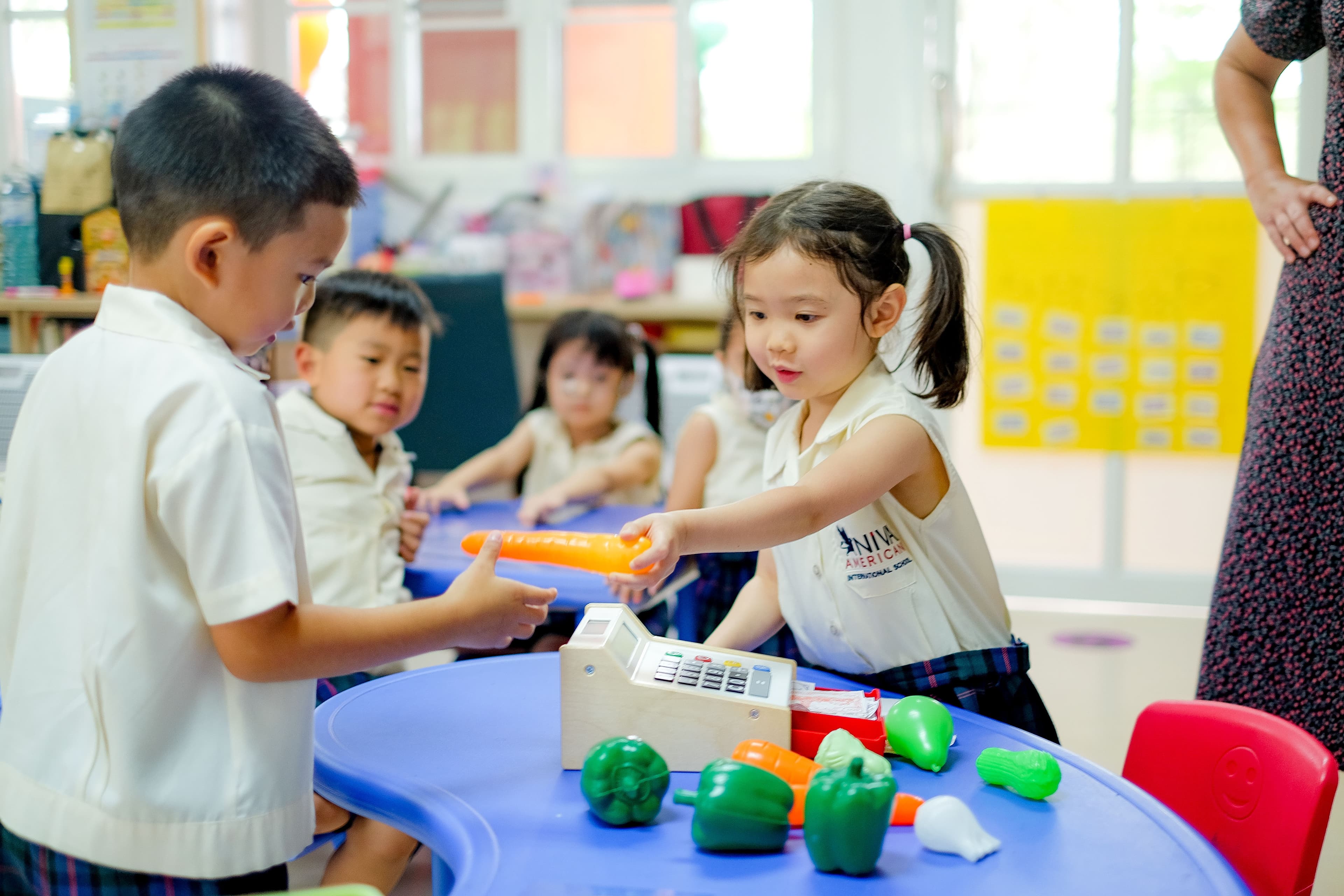 NIVA American International School kindergarten students engaging in a supermarket roleplay