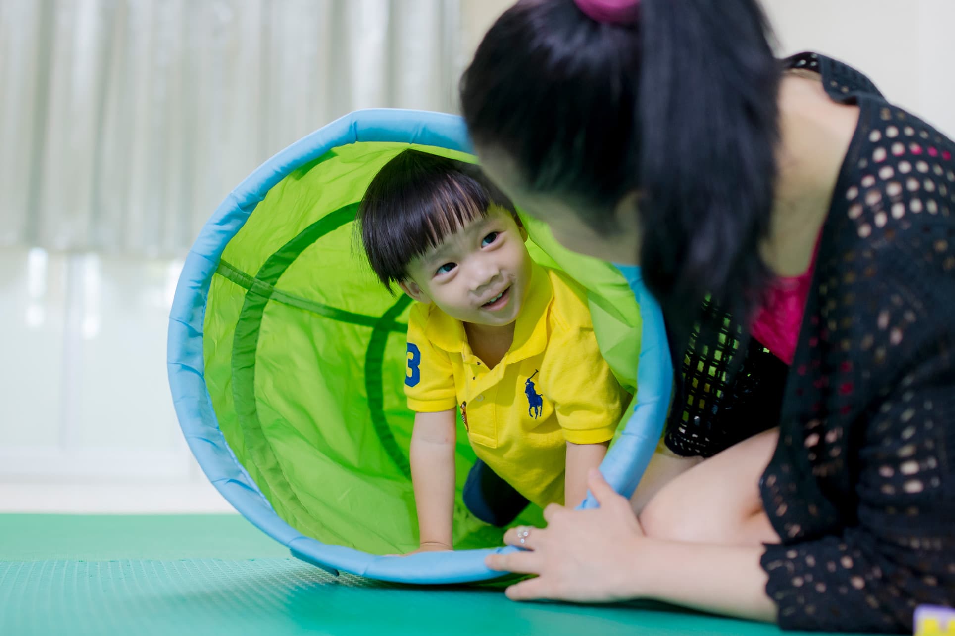 Nursery boy coming out of a tunnel