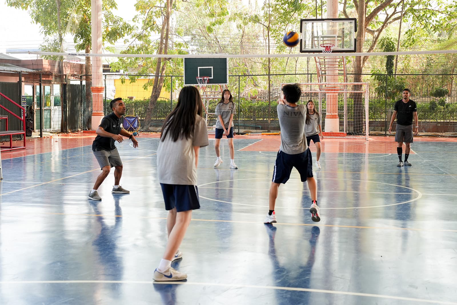 NIVA Multipurpose Court - A student receiving a volleyball