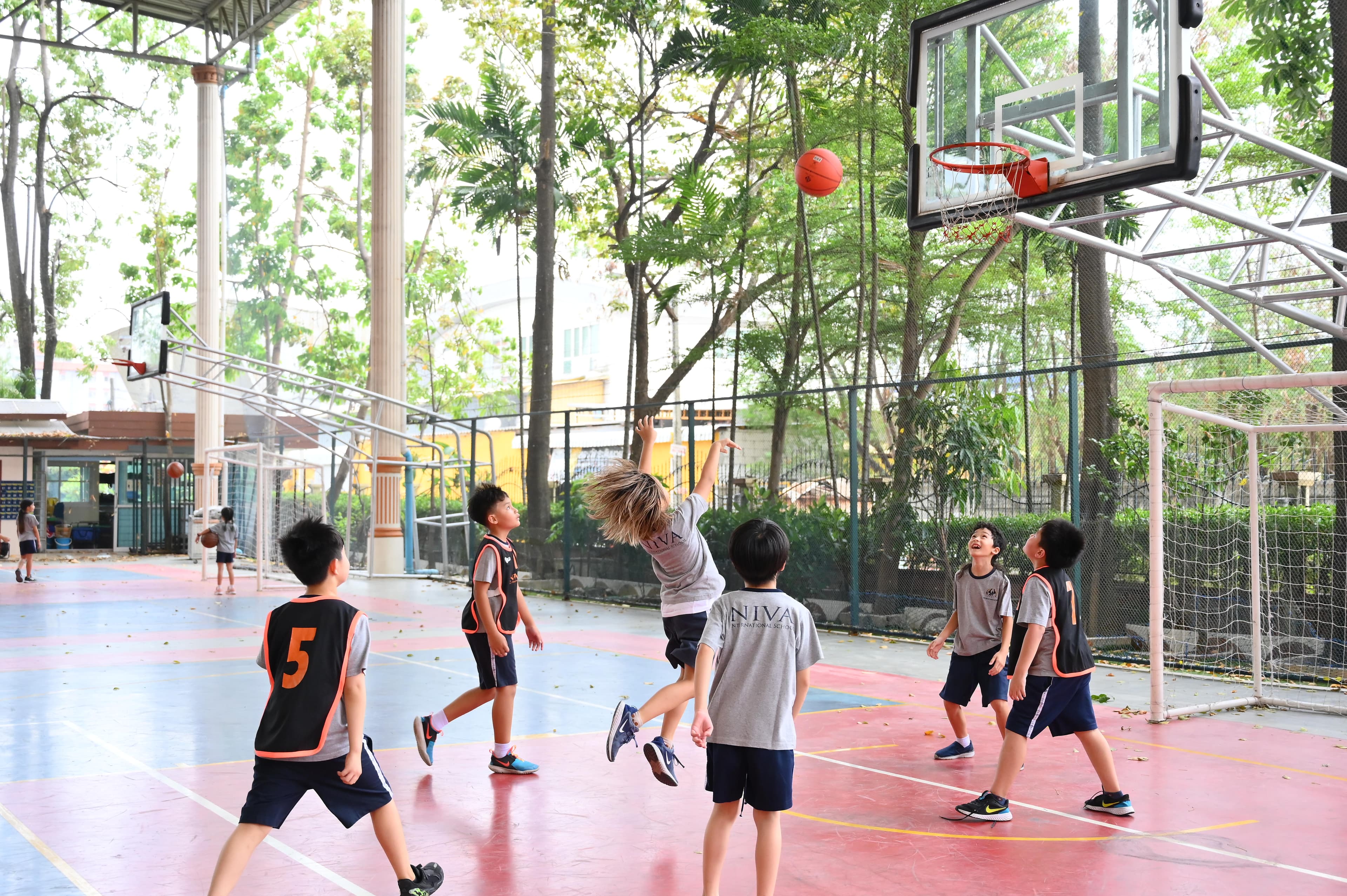 NIVA Multipurpose Court - Students shooting a basketball in a game