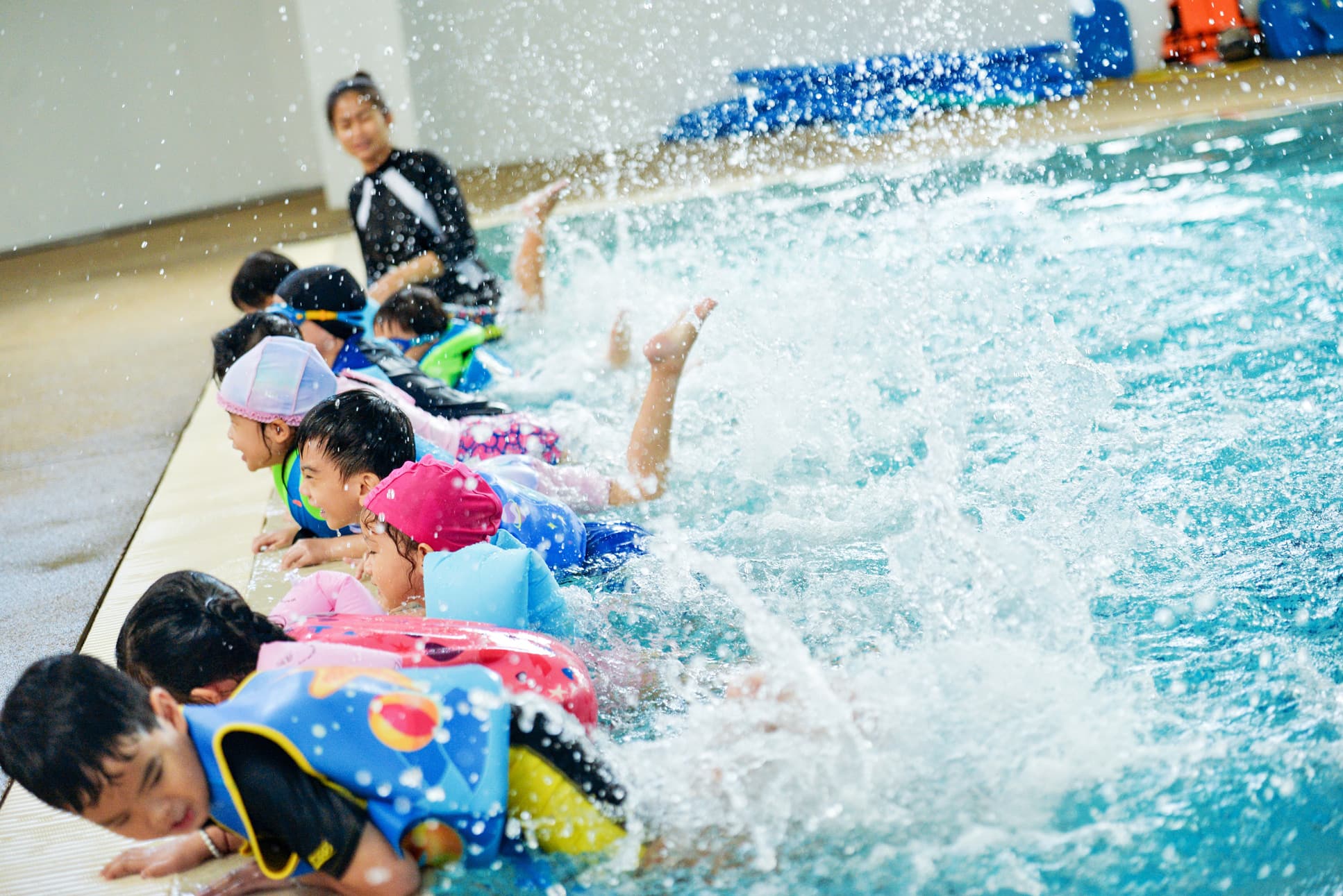 NIVA Swimming Pool - Students practicing kicks in the swimming pool