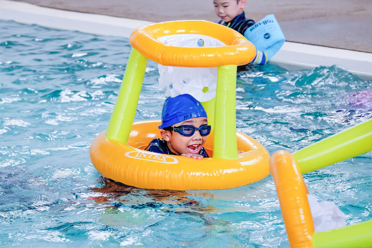 Child swimming with a yellow flotation aid