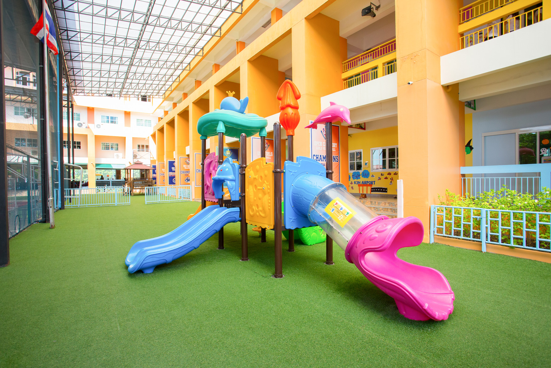Colorful playground slides beside the school building