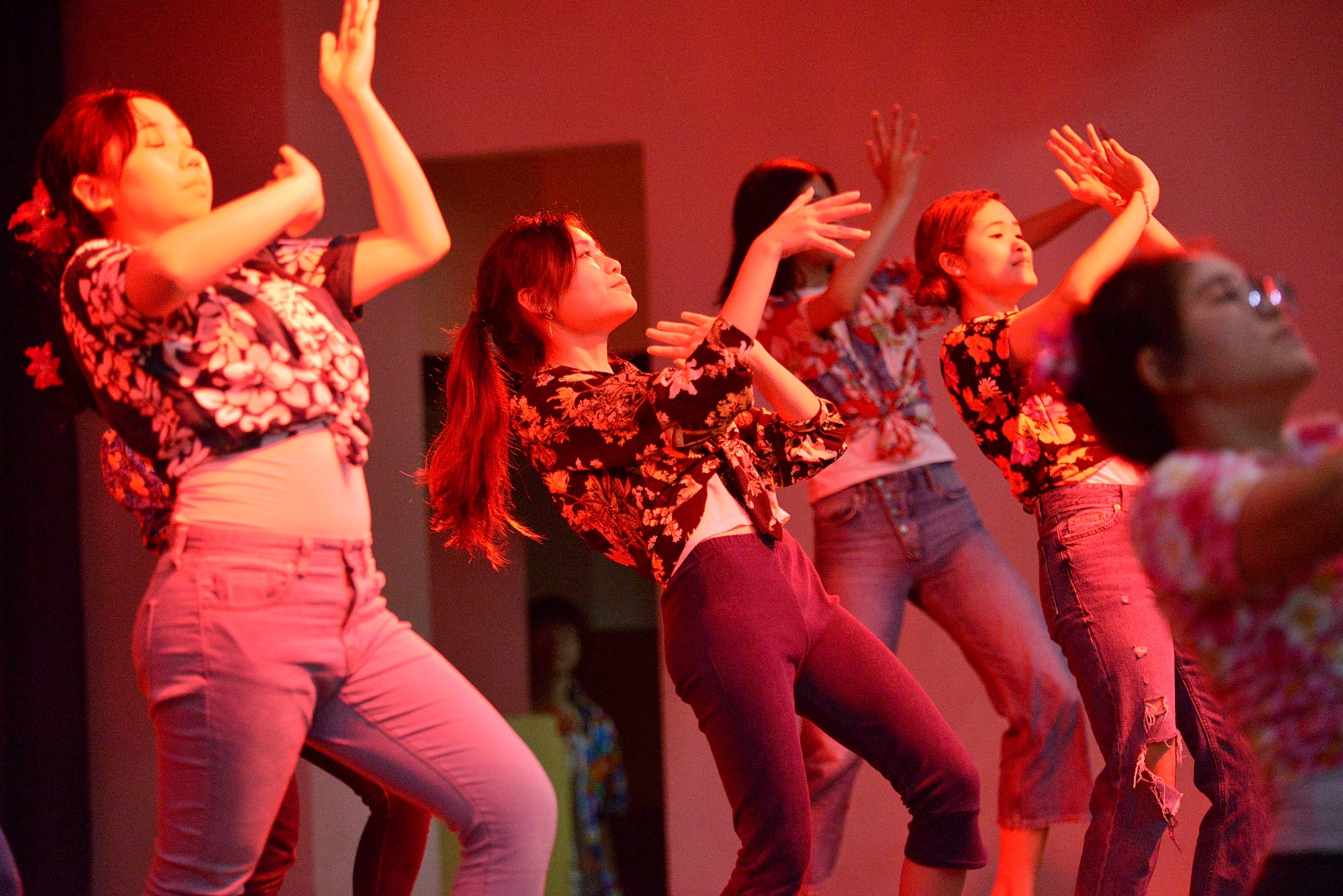 Students dancing on stage at a Songkran celebration