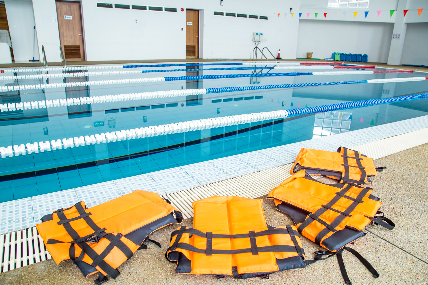 Life jackets laid out beside the swimming pool