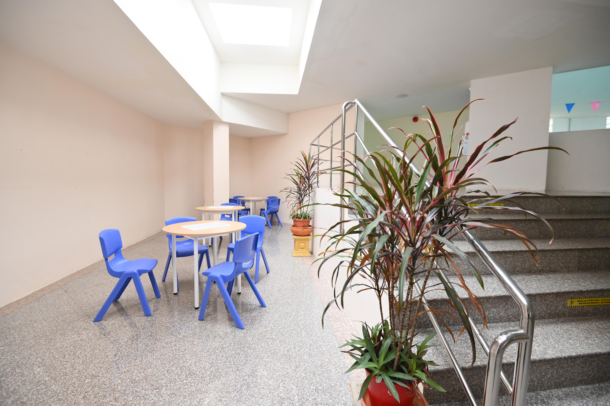 Tables and chairs beside the stairs on the second floor