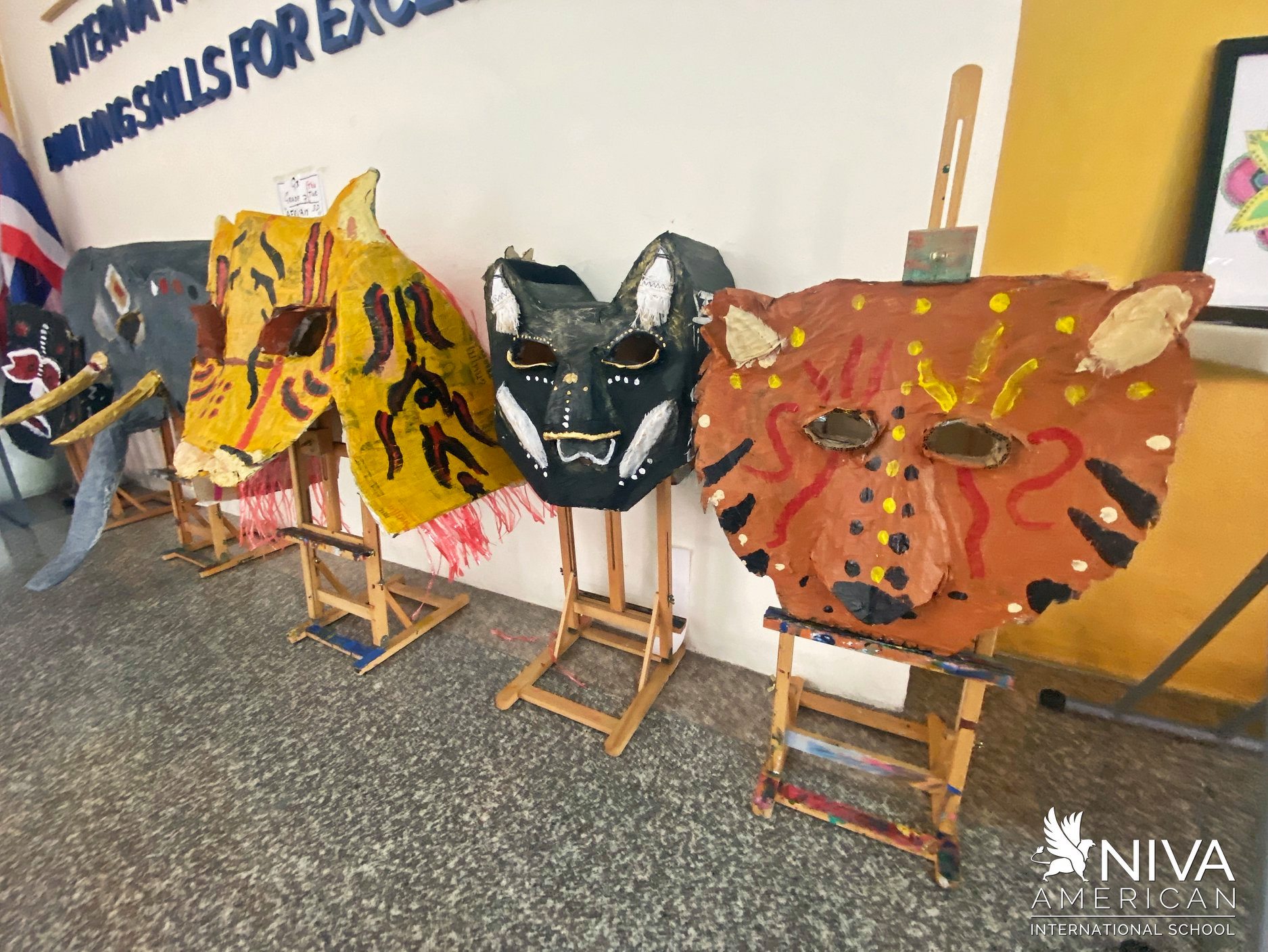 Painted masks displayed on easels