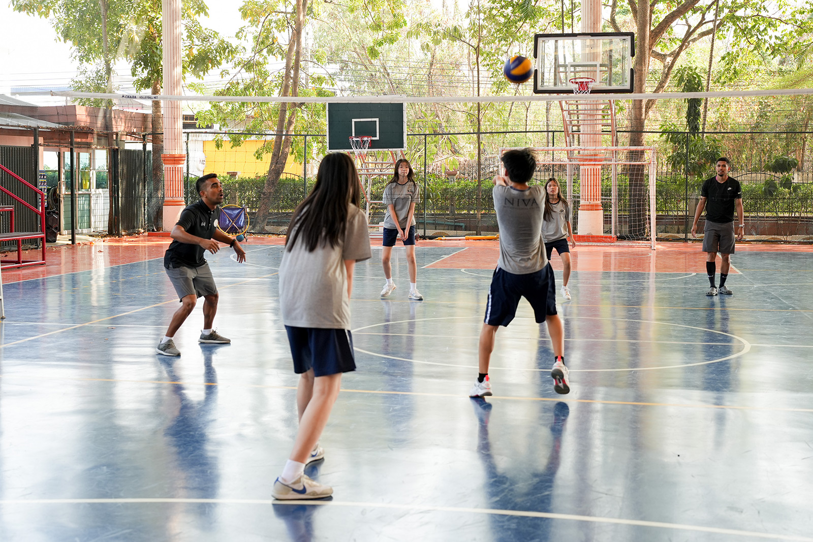 Students preparing to receive a volleyball
