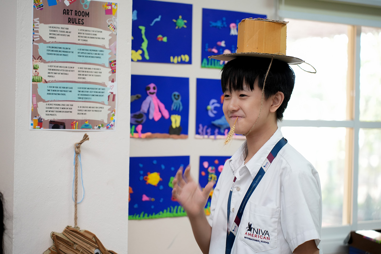 Student wearing a handmade hat from an art project
