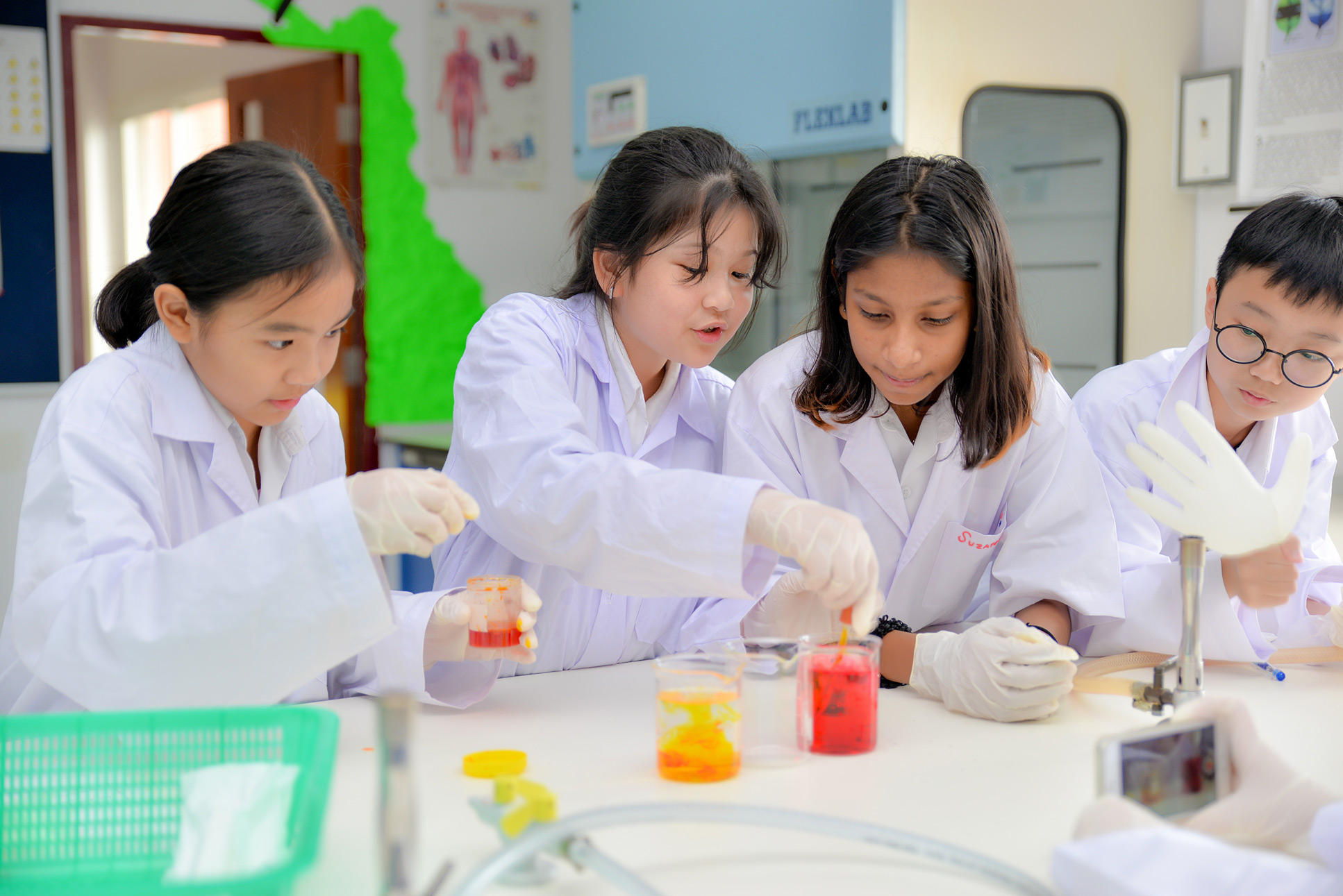 Students mixing liquids during a science experiment