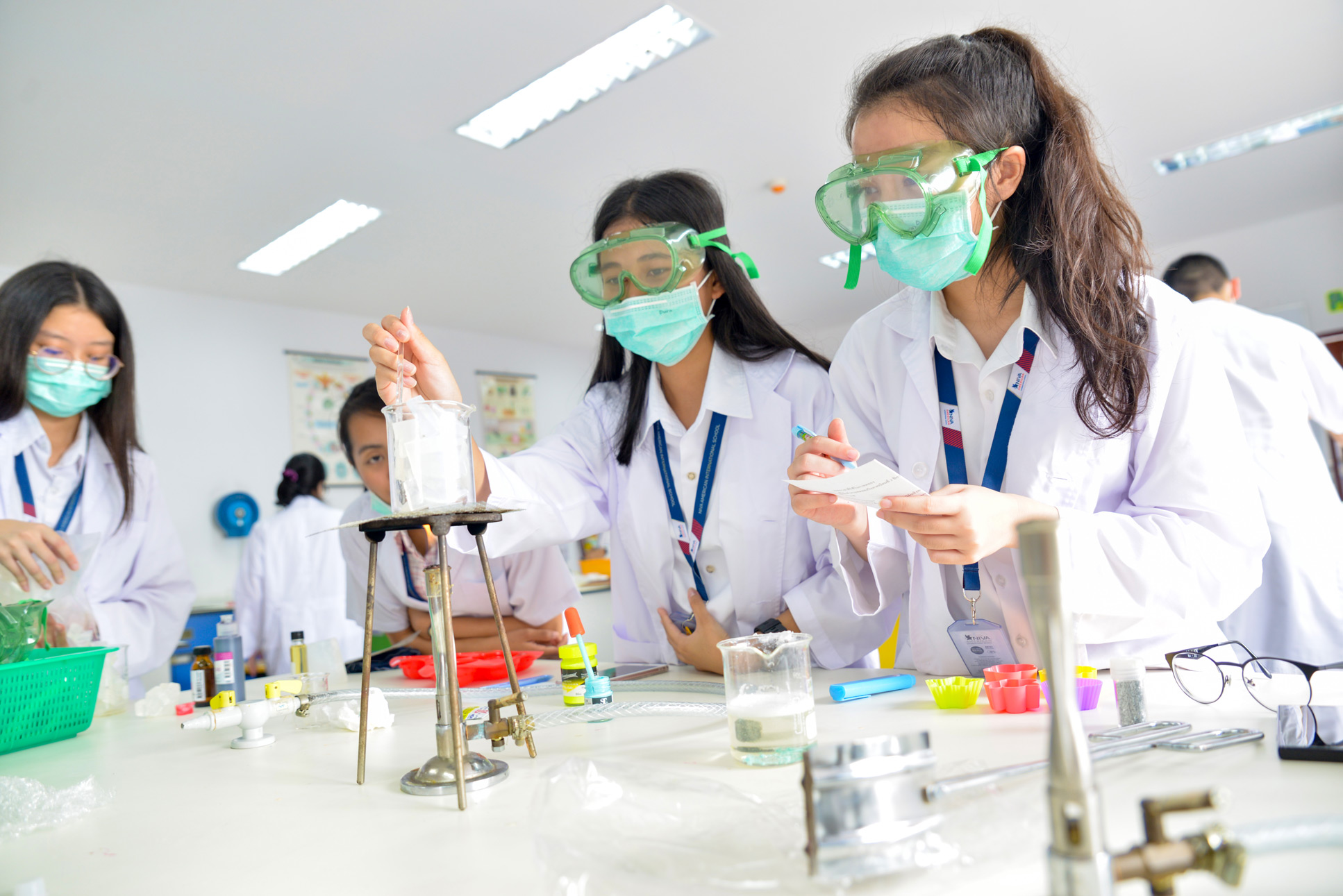 Students using beakers and glassware in the science lab